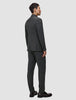 En mann sett bakfra, kledd i en Motion Blazer Regular Pepper Grey-blazer og matchende bukser i pustende materiale.