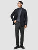 En mann i svart blazer og grå turtleneck har på seg Motion Suit Pants Regular Pepper Grey med skandinavisk design.