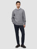 En mann i en grå genser, hvit skjorte med krage og Midnight Blue Motion Suit Pants Slim i skandinavisk design.