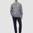 En mann i en grå genser, hvit skjorte med krage og Midnight Blue Motion Suit Pants Slim i skandinavisk design.