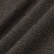 Nærbilde av Atelier Pants Relaxed Dark Brown i brettet mørkebrunt stoff med et strukturert, brutt twill-vev.