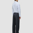 En mann sett bakfra, iført en Elevated Shirt Slim Classic Blue Striped, som er stappet ned i mørkegrå bukser og svarte loafers.