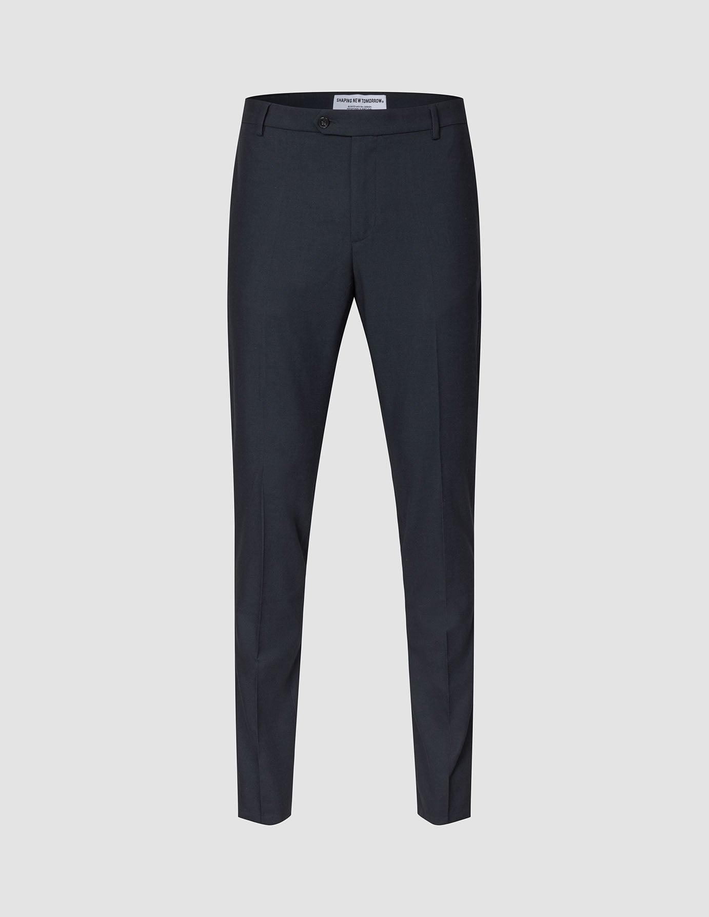 Motion Suit-bukse, slim, midnattsblå: mørkeblå dressbukse i slim fit med knappelukking, presselinjer foran og 360°-stretch.