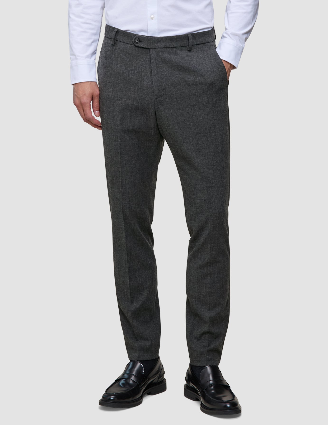 Motion Suit Pants Slim Pepper Grey – dressbukser i slim fit, kombinert med en hvit skjorte med knapper og svarte loafers.