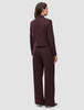 En person sett bakfra, kledd i en Women Serene Short Jacket Berry Pinstripe med matchende bukser med vide ben.